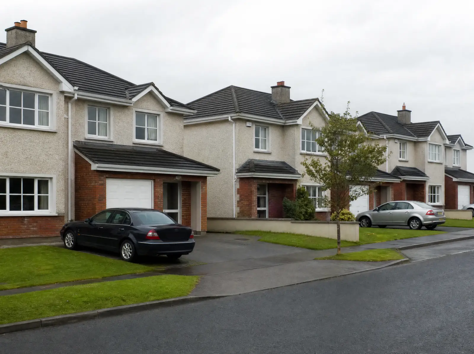Row of 2000s semi-detached houses with integral garages in Naas, County Kildare