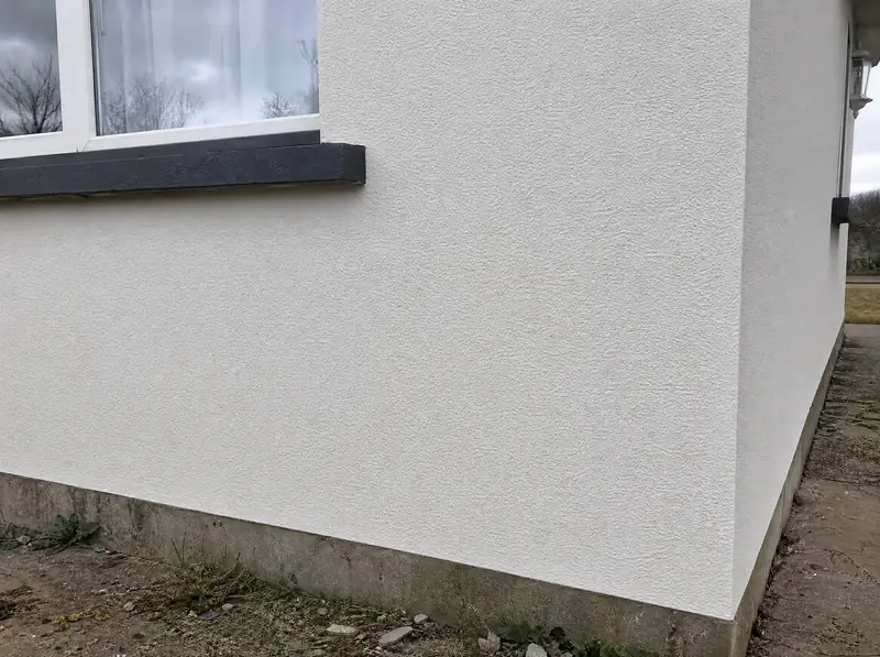 After: the same wall corner with the crack repaired and the render made good and painted