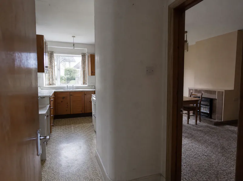 Before: separate kitchen and dining room divided by a load-bearing wall in a 1970s Dublin semi