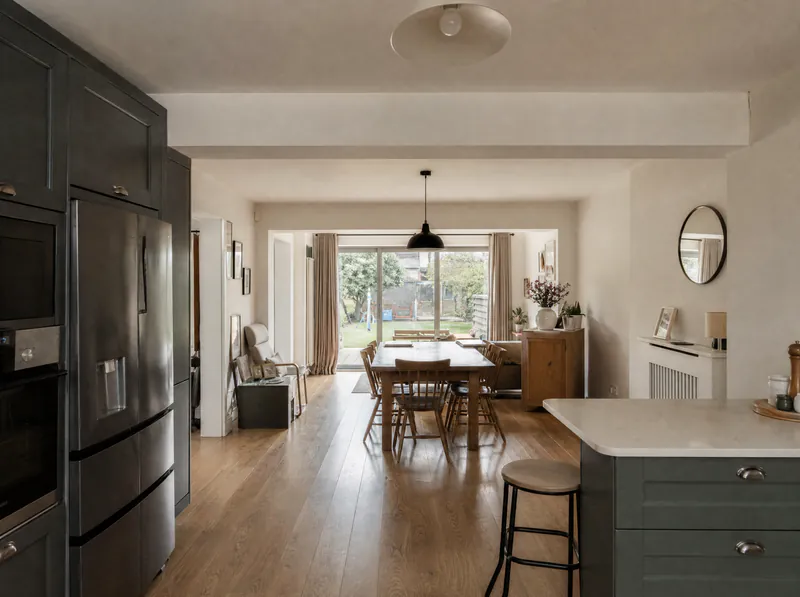 Finished open-plan kitchen with the boxed-in beam where the wall used to be
