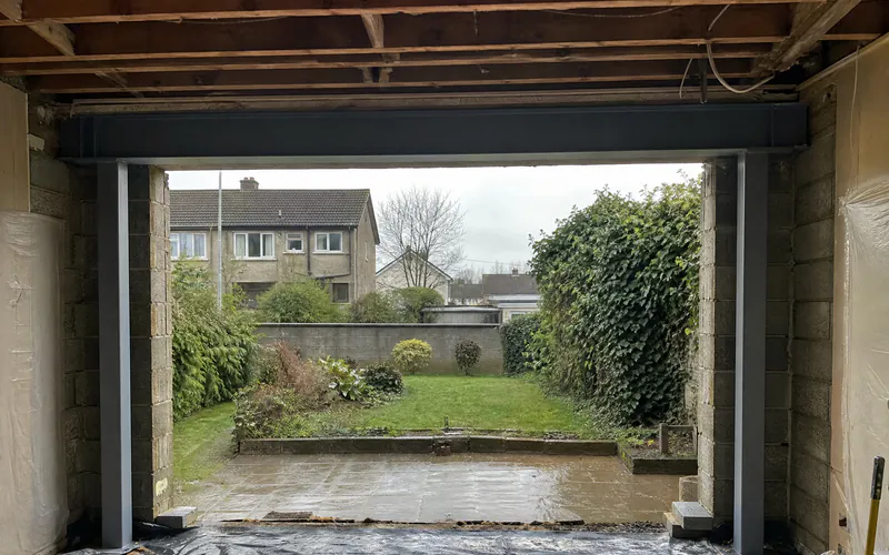 Steel goalpost frame in a widened rear wall opening ready for sliding doors in an Irish semi