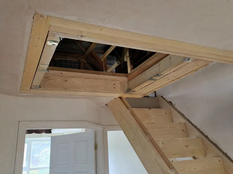 Trimmed stair opening with doubled joists for an attic conversion staircase