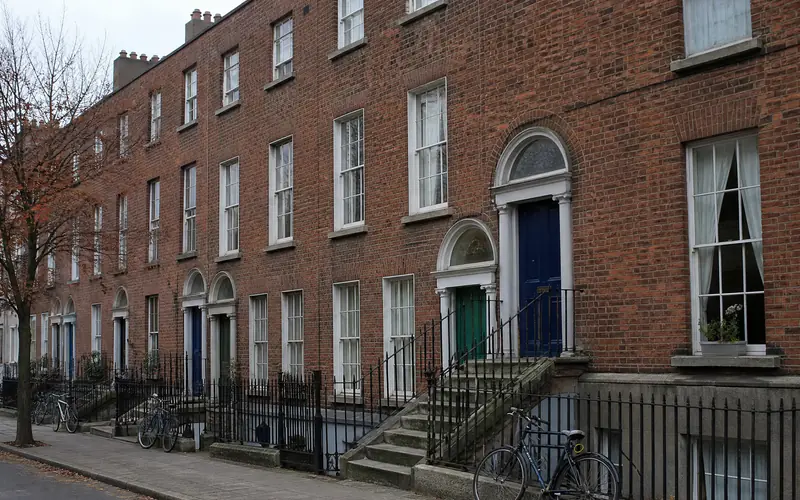 Victorian red-brick terrace over basements with cast-iron railings on a south Dublin street